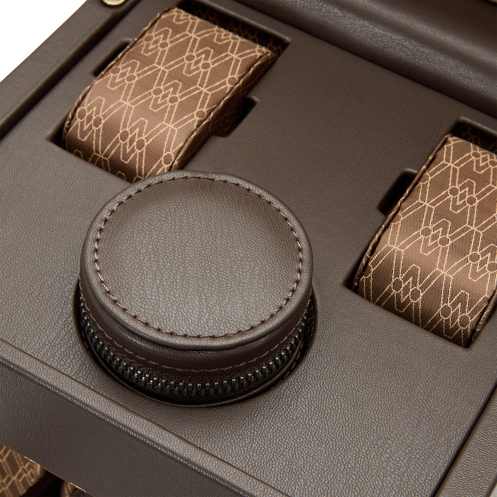 Brown leather tie set with geometric patterned tie and matching pocket square in a box.