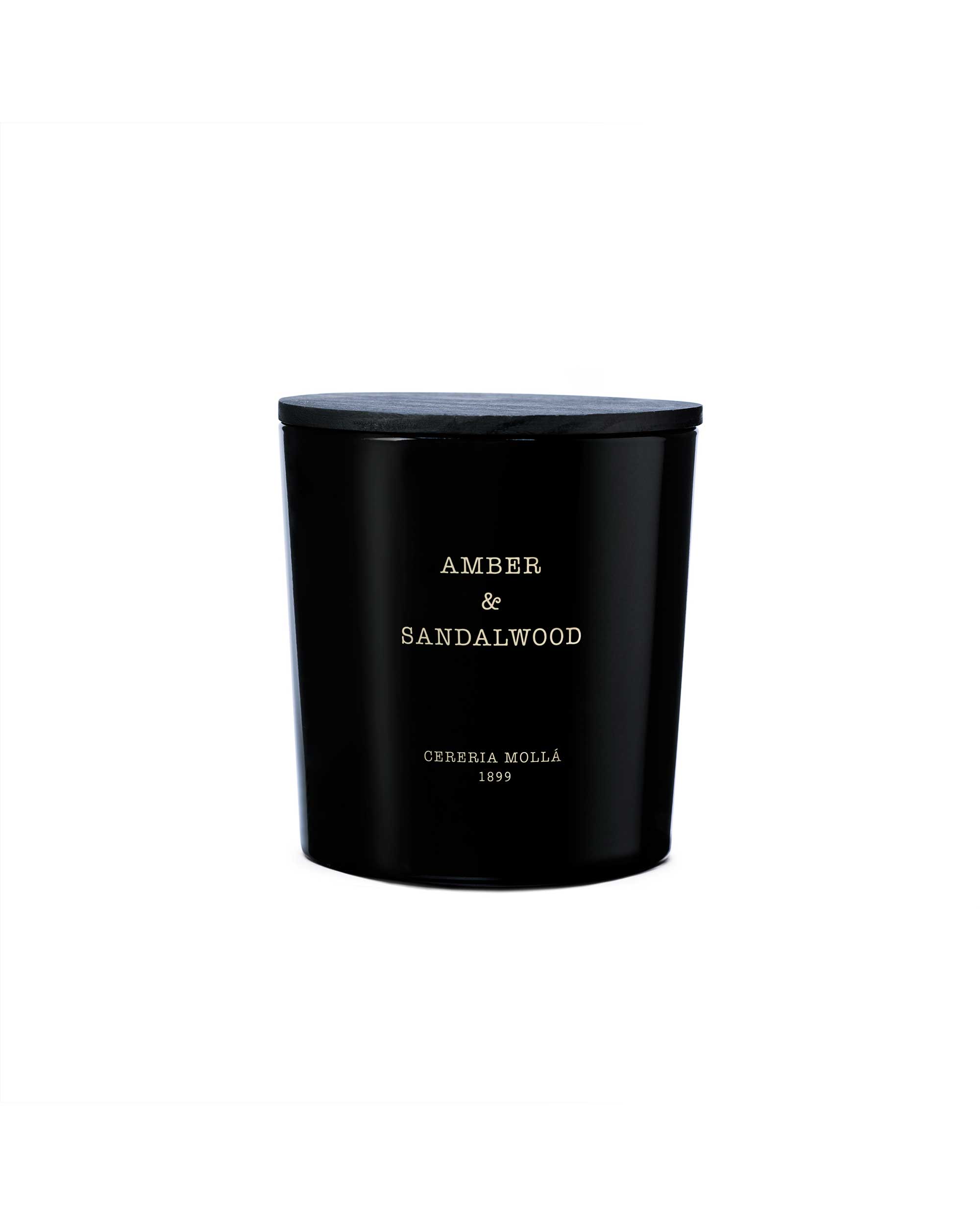 Black candle with 'Amber & Sandalwood' text on a white background