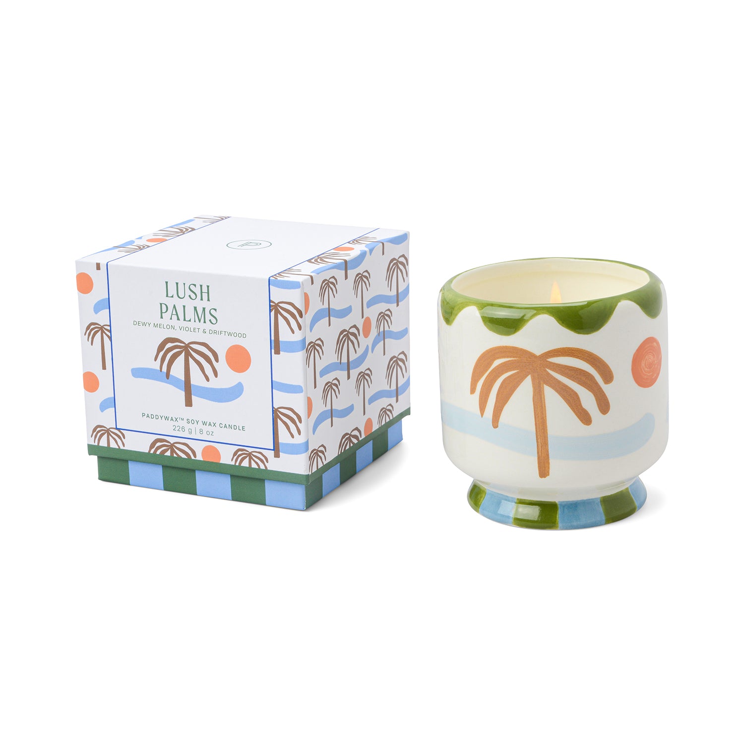 A hand-painted ceramic candle with a palm tree design, accompanied by its packaging which has a similar palm tree illustration.