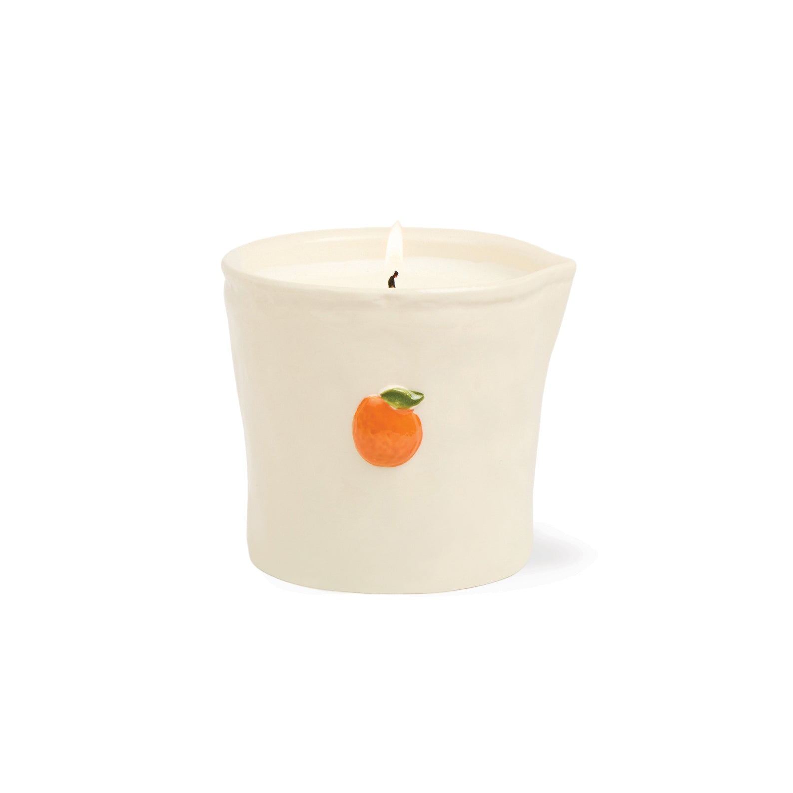 An off-white ceramic candle holder with a lit candle inside, featuring a small orange and green ORANGE citrus fruit illustration on the front, set against a plain white background.