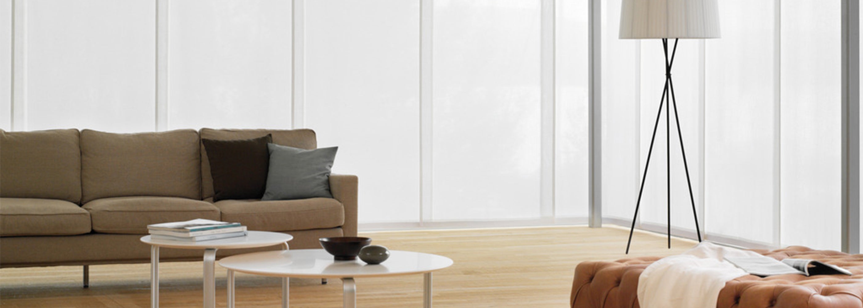 Modern living room featuring sleek, floor-to-ceiling blinds from Iroka Interiors' bespoke blinds collection in Cornwall.
