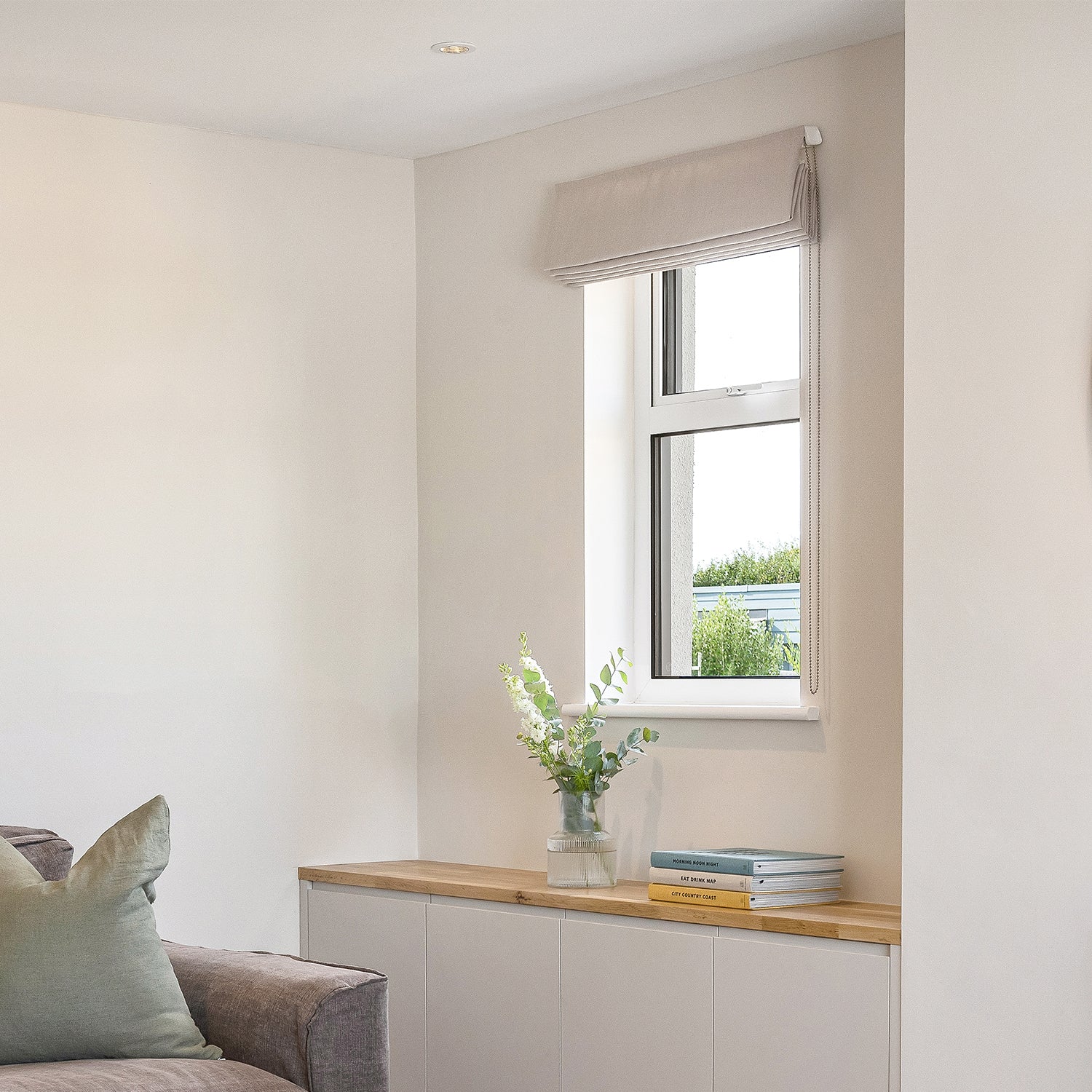 Tailored Roman blind in a bright Cornwall coastal home, designed and installed by Iroka to complement contemporary interiors.