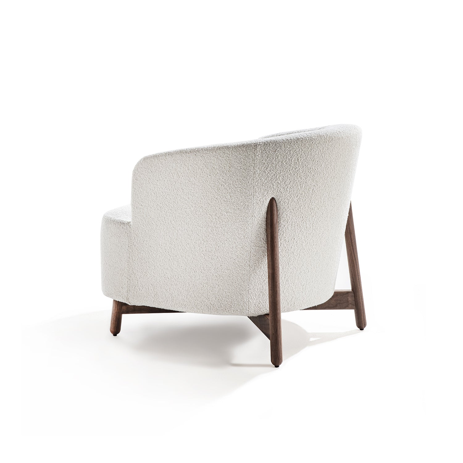 Modern armchair with wooden legs on a white background