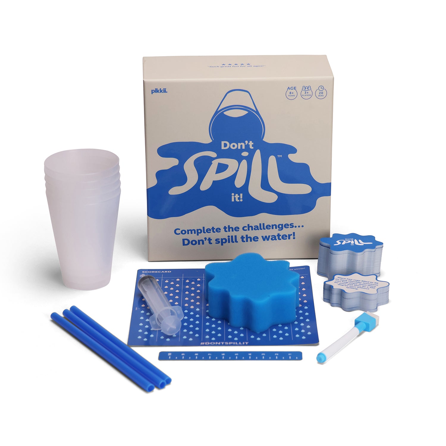 dont spill it GAME on a white background, including a cardboard box labelled 'Don't spill it!', a stack of translucent plastic cups, blue straws, a blue star-shaped mold, a small clear tube, a ruler, and metal cup formers.