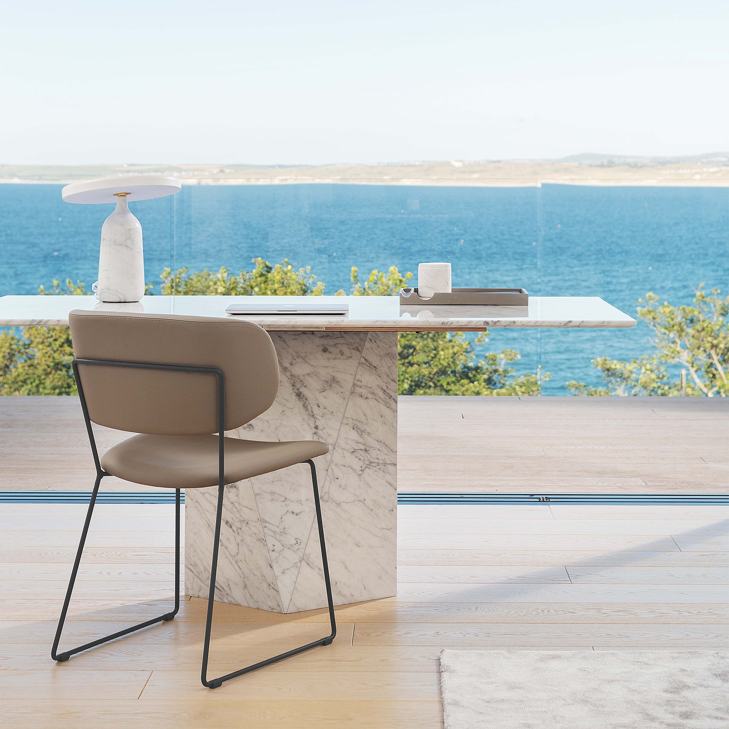 Light oak wood flooring in a minimalist coastal home office with marble desk and panoramic sea views – luxury flooring by Iroka Interiors in Cornwall.