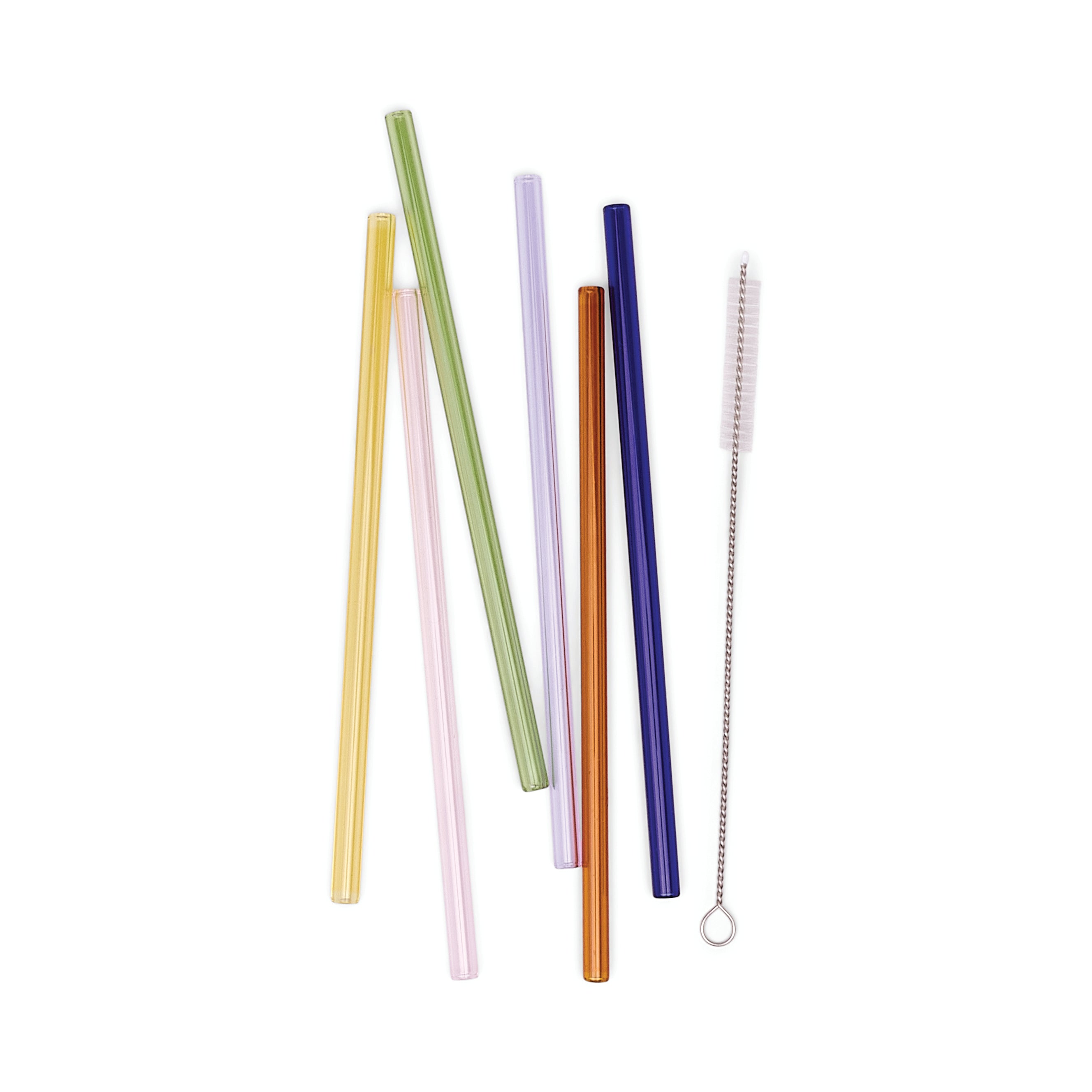 Set of colorful straws and a cleaning brush on a white background