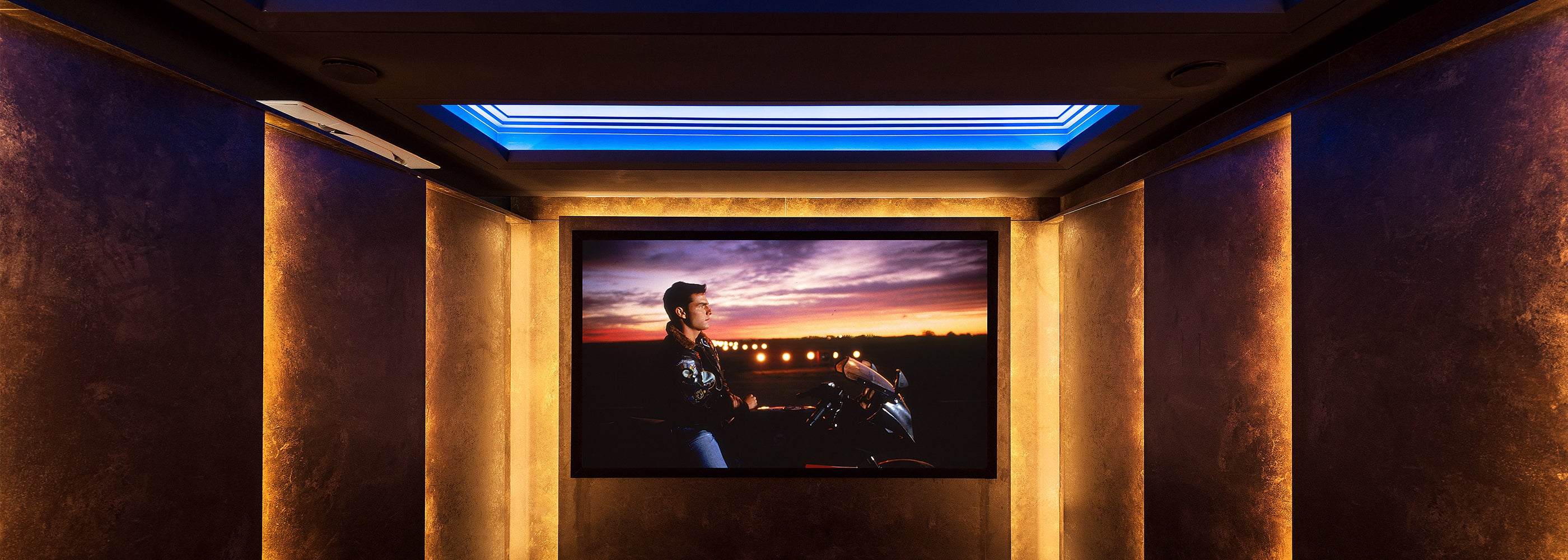 Luxury cinema room design package featuring integrated LED lighting, acoustic wall panels, and widescreen projector display – bespoke home theatre solutions by Iroka Interiors Cornwall.