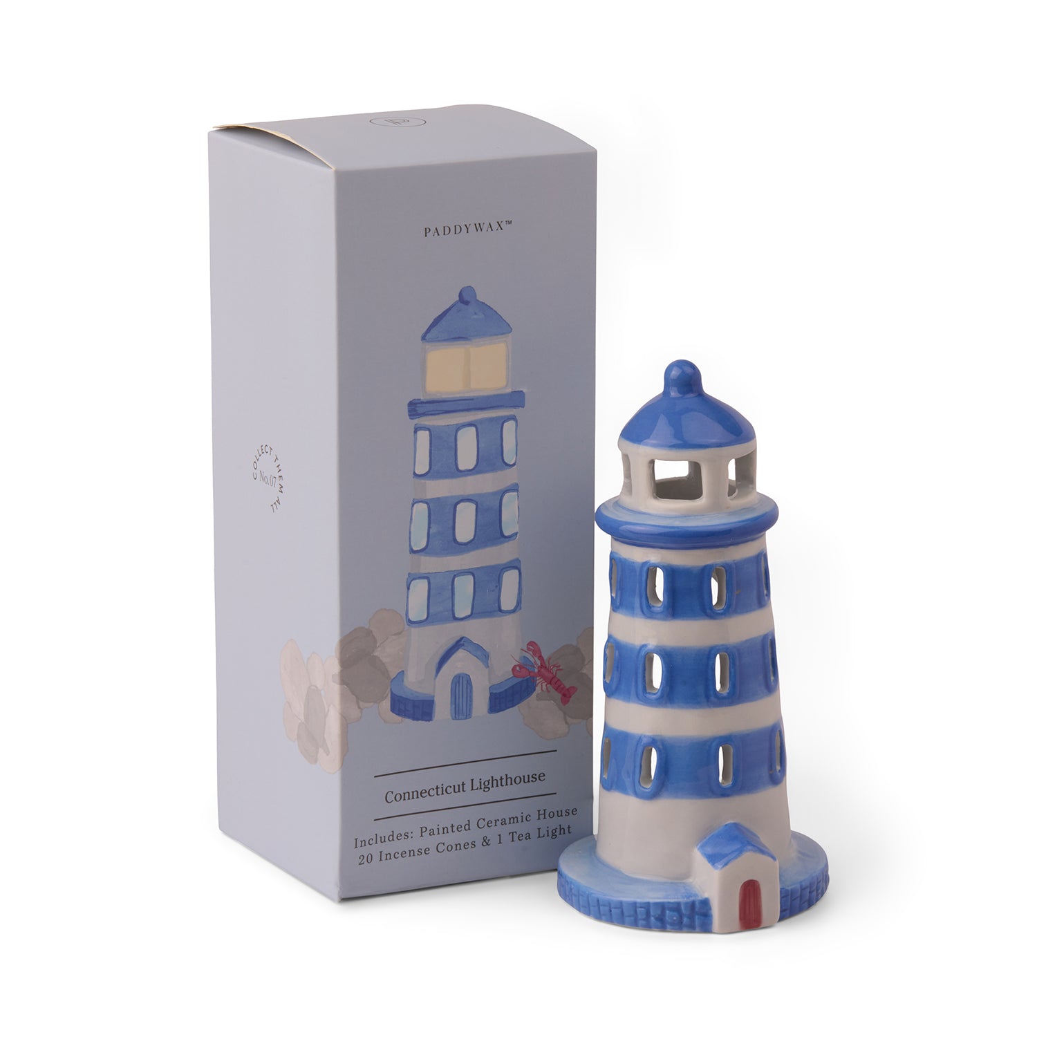 A hand-painted lighthouse-shaped incense and tea light holder, with a printed box in the background.