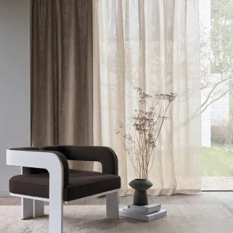 Elegant curtains made with luxurious Casamance fabrics in a modern interior , showcasing layered sheer and blackout drapery.