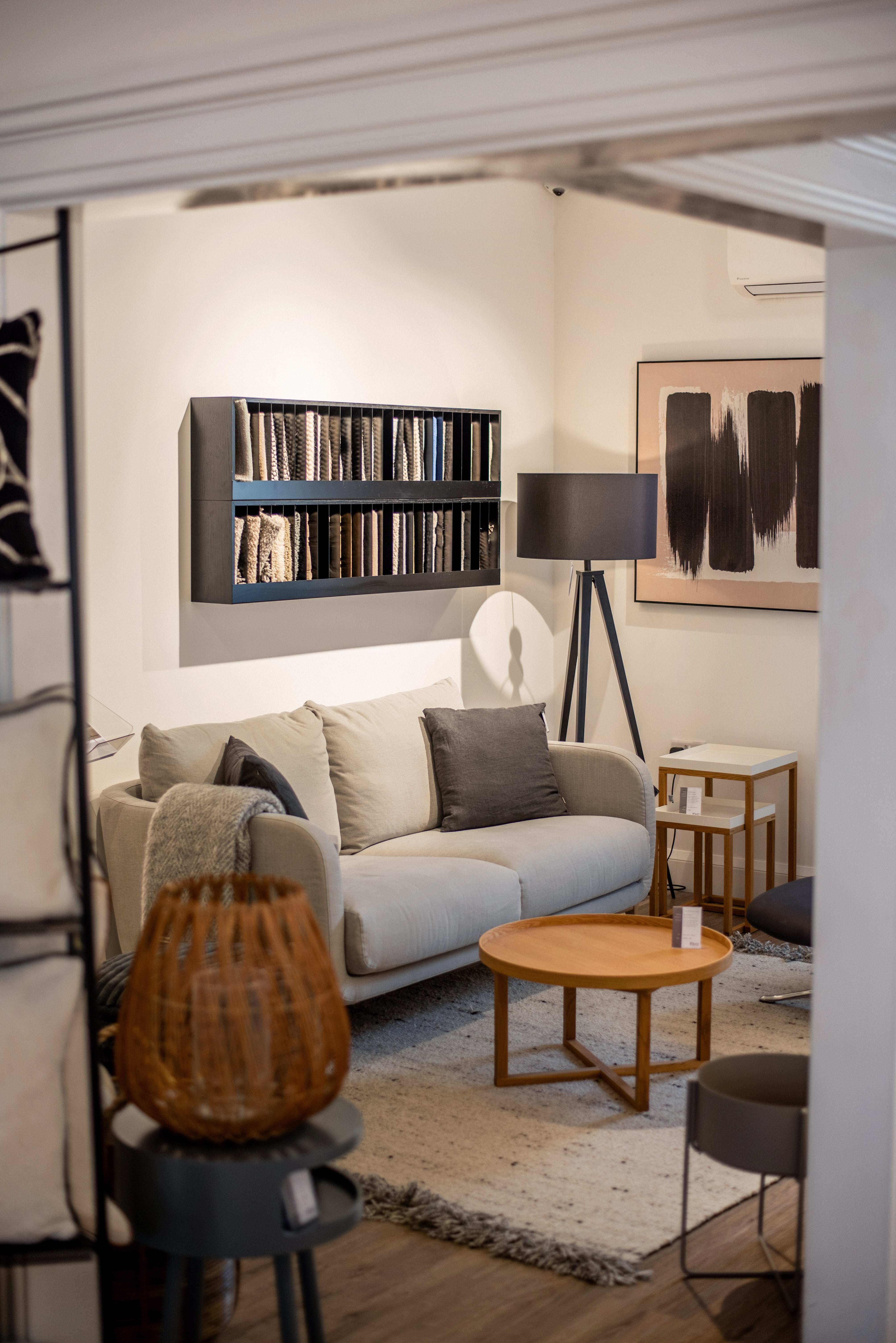 Modern living room with a gray sofa, wooden coffee table, and decorative items.
