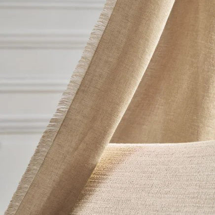 Casamance Kanso curtain in soft beige linen with subtle fringing, for a minimalist, natural finish.