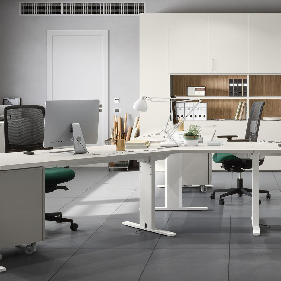 Modern commercial office interior designed by Iroka Interiors, featuring ergonomic workstations with mesh chairs, white modular desks, integrated storage, and minimalist décor for a productive workspace environment in Cornwall.