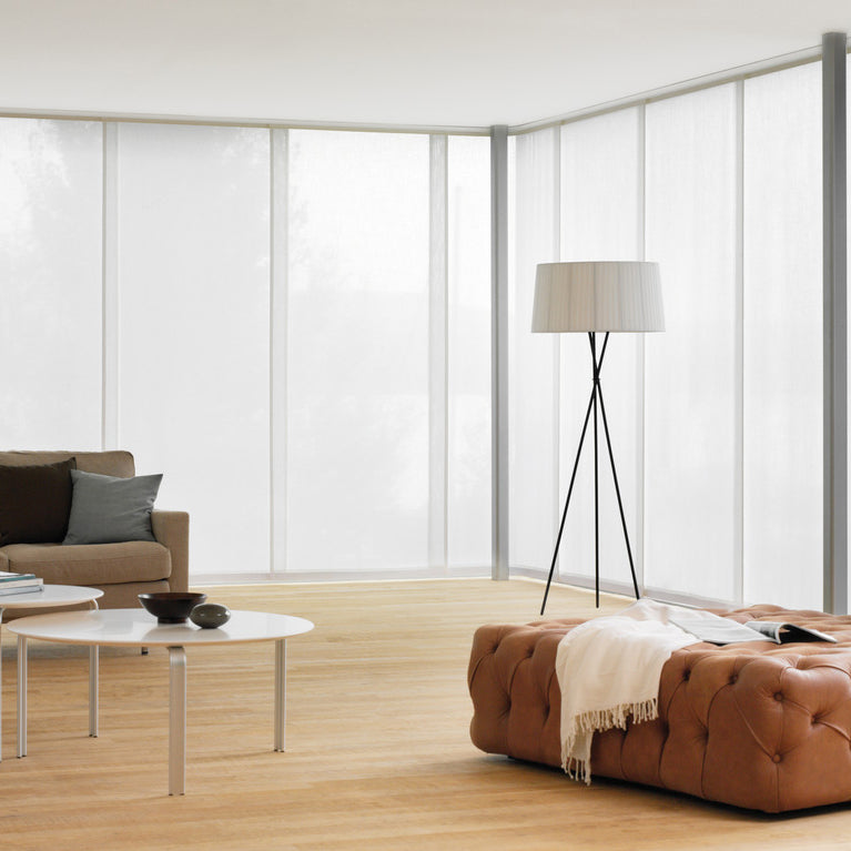 Contemporary panel blinds in a modern Cornwall living space, offering elegant light control and minimalist design for large windows.
