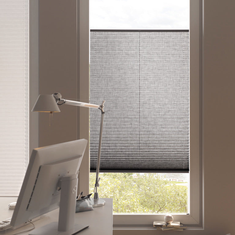 Modern home office with grey pleated blinds by Iroka Interiors, offering light filtering and privacy solutions tailored for stylish interiors in Cornwall.