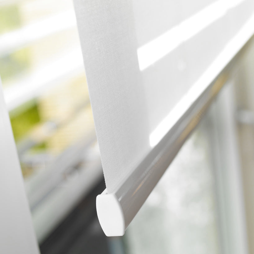 Minimal white roller blind detail by Iroka Interiors, showcasing smooth mechanism and precision finish for contemporary window treatments in Cornwall homes.