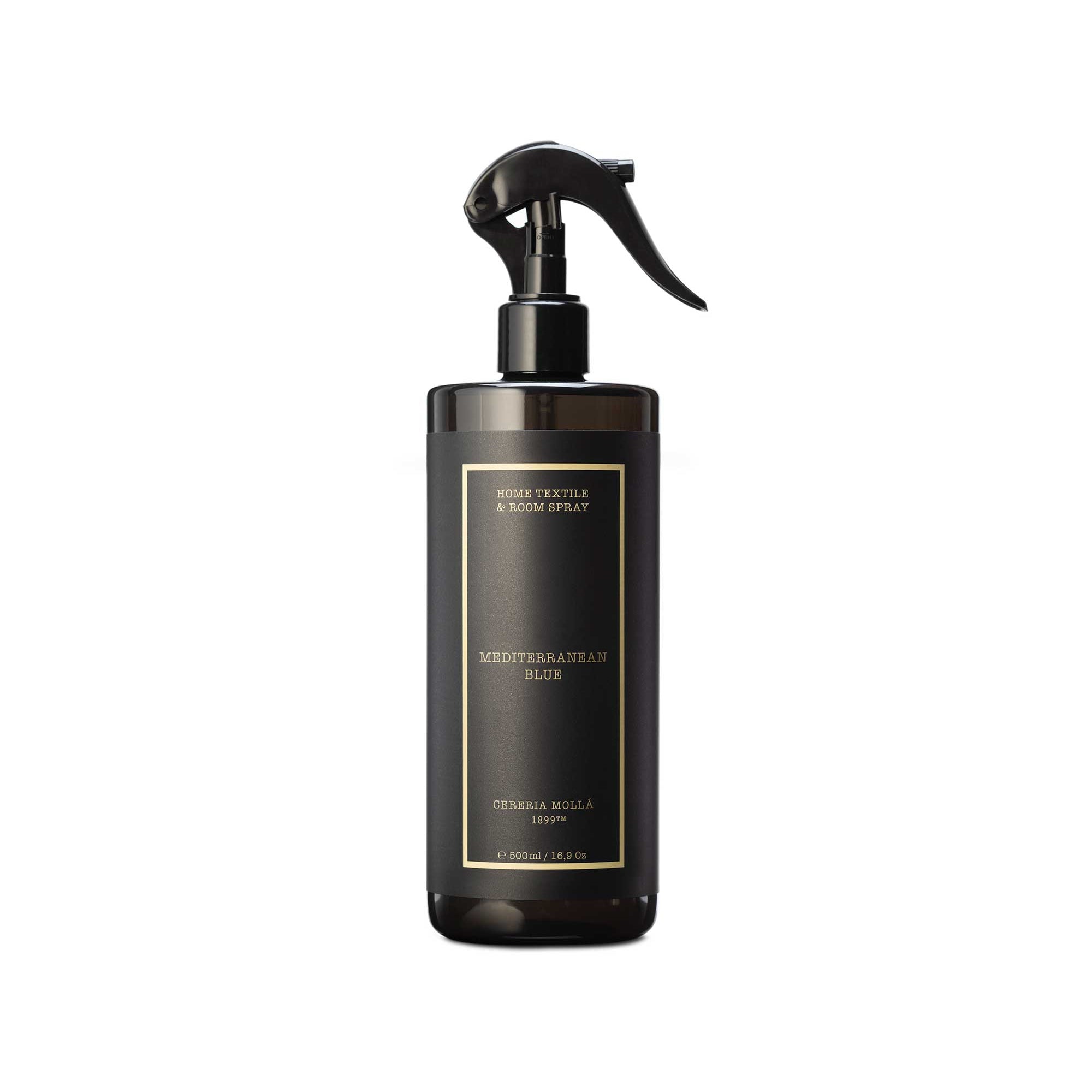 A dark brown glass spray bottle with a black trigger sprayer and a gold-bordered label, shown against a plain white background.