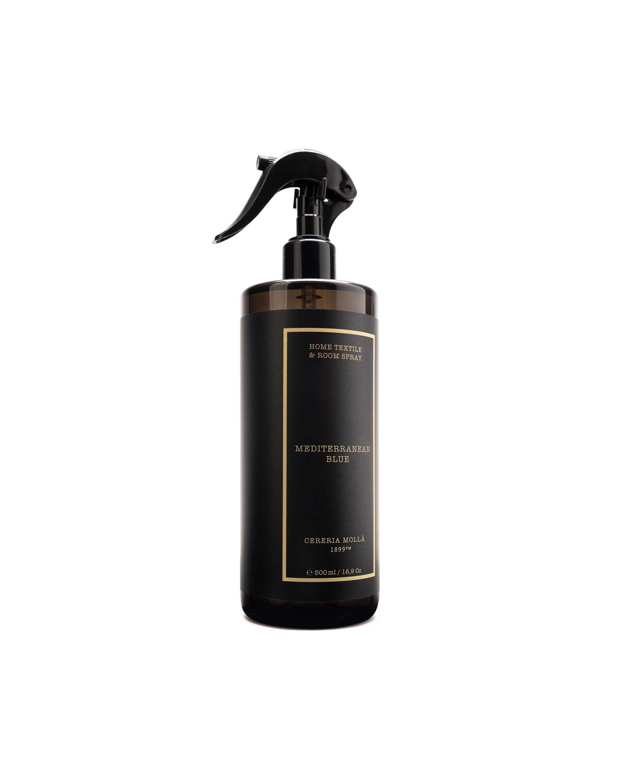 A dark brown glass spray bottle with a black trigger sprayer and a black label featuring gold text, set against a plain white background.