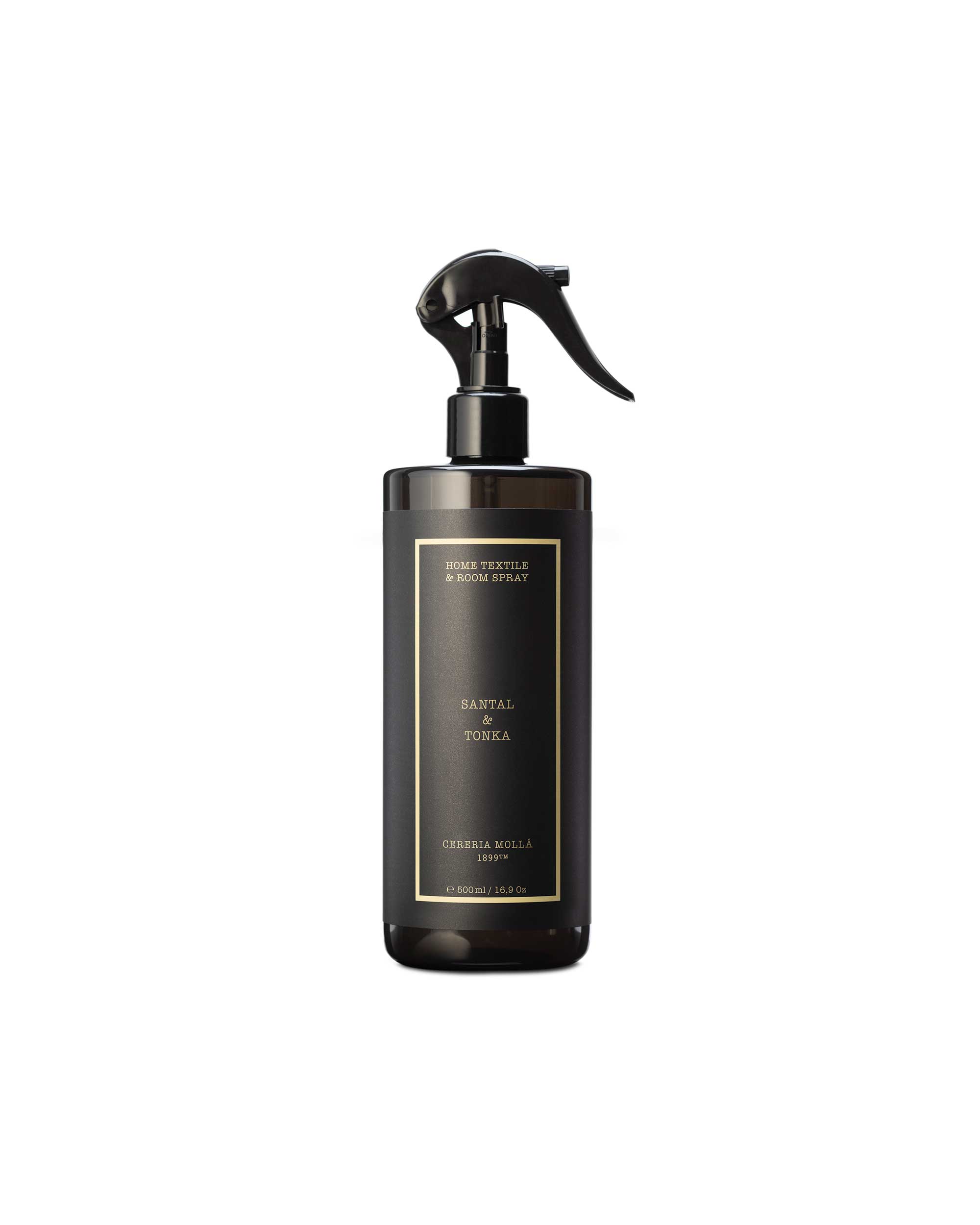 A dark brown glass spray bottle with a black trigger sprayer and a gold-bordered label reading 'santal & tonka' on a plain white background.