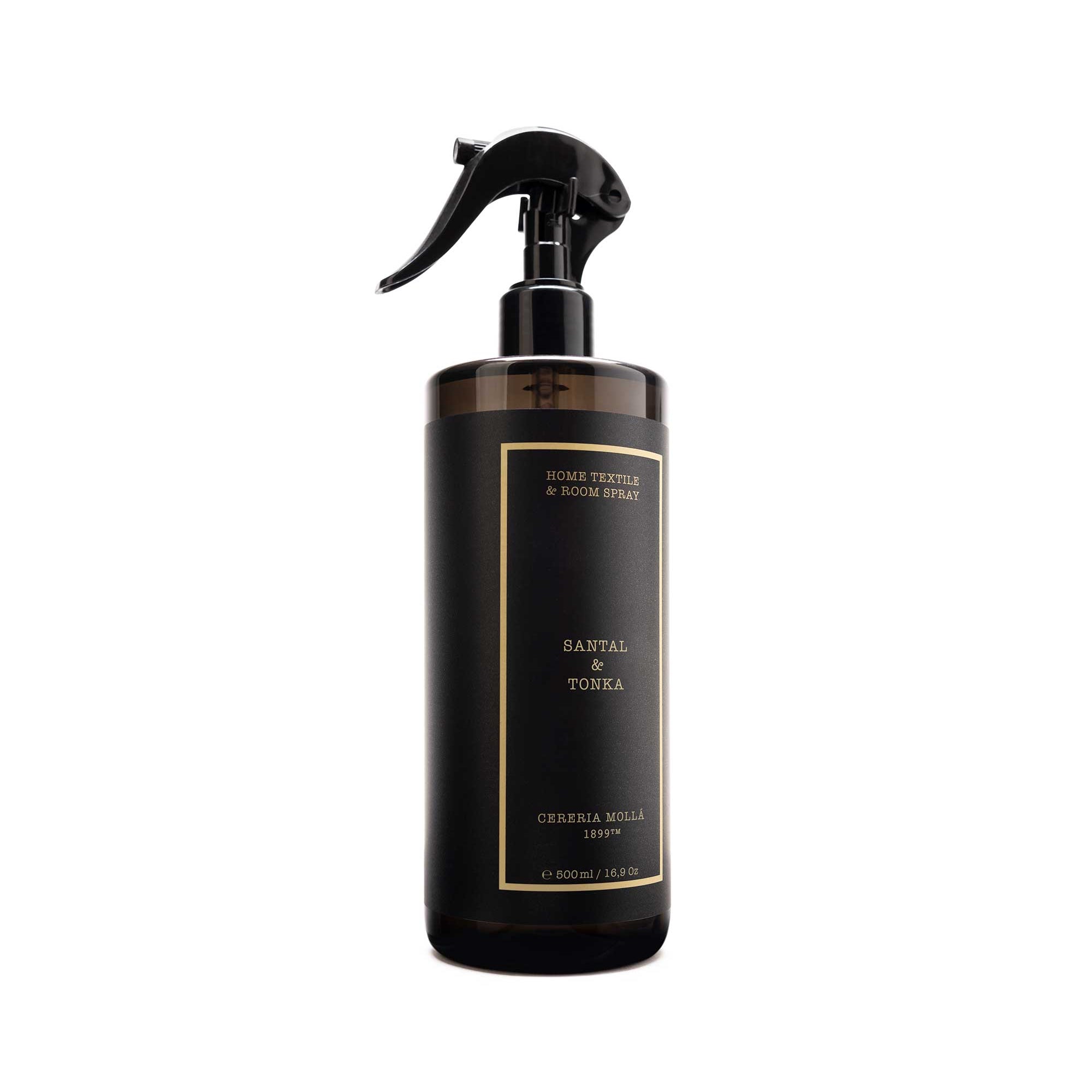A dark brown glass spray bottle with a black trigger sprayer and a black label featuring gold text, labeled 'santal & tonka and 'Cereria molla.