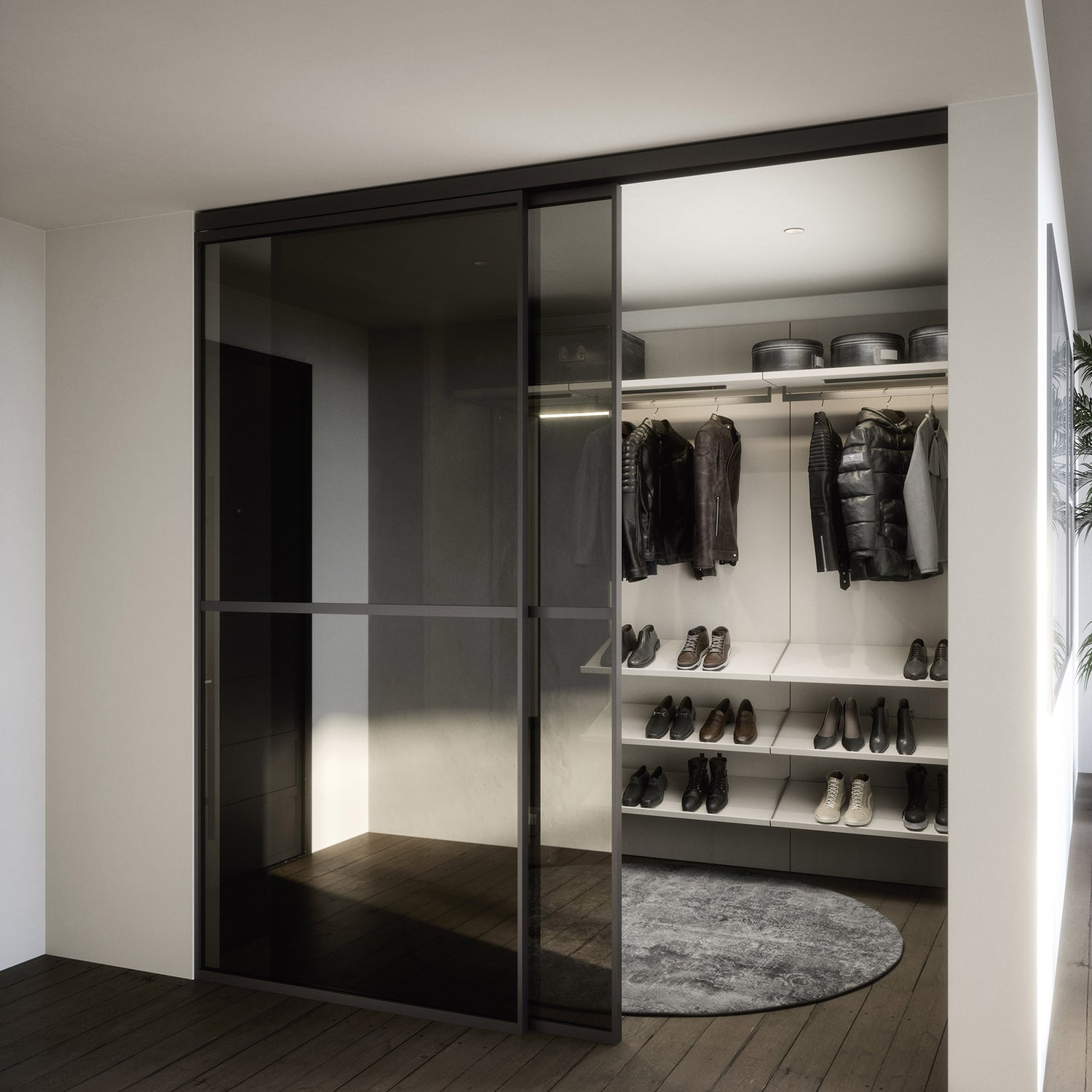 Luxury walk-in wardrobe with dark glass sliding doors, open shelving for shoes, overhead storage, and minimalist hanging space with integrated lighting – modern closet design inspiration for contemporary interiors.