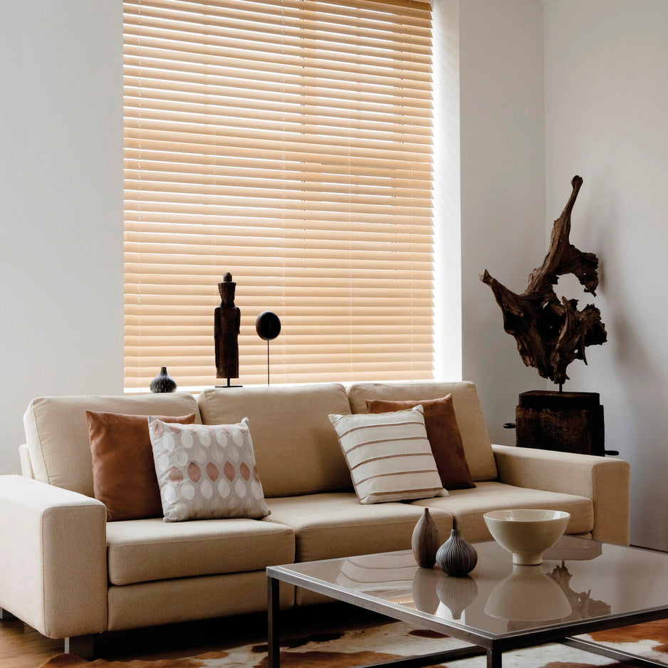 Contemporary living room featuring natural wood Venetian blinds by Iroka Interiors, combining privacy and light control with timeless interior style in Cornwall.