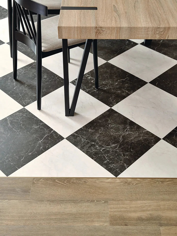 Modern dining space with Amtico checkerboard luxury vinyl tiles in Nero and Bianca Classic Marble – a bold black and white flooring design paired with natural wood-effect LVT planks.