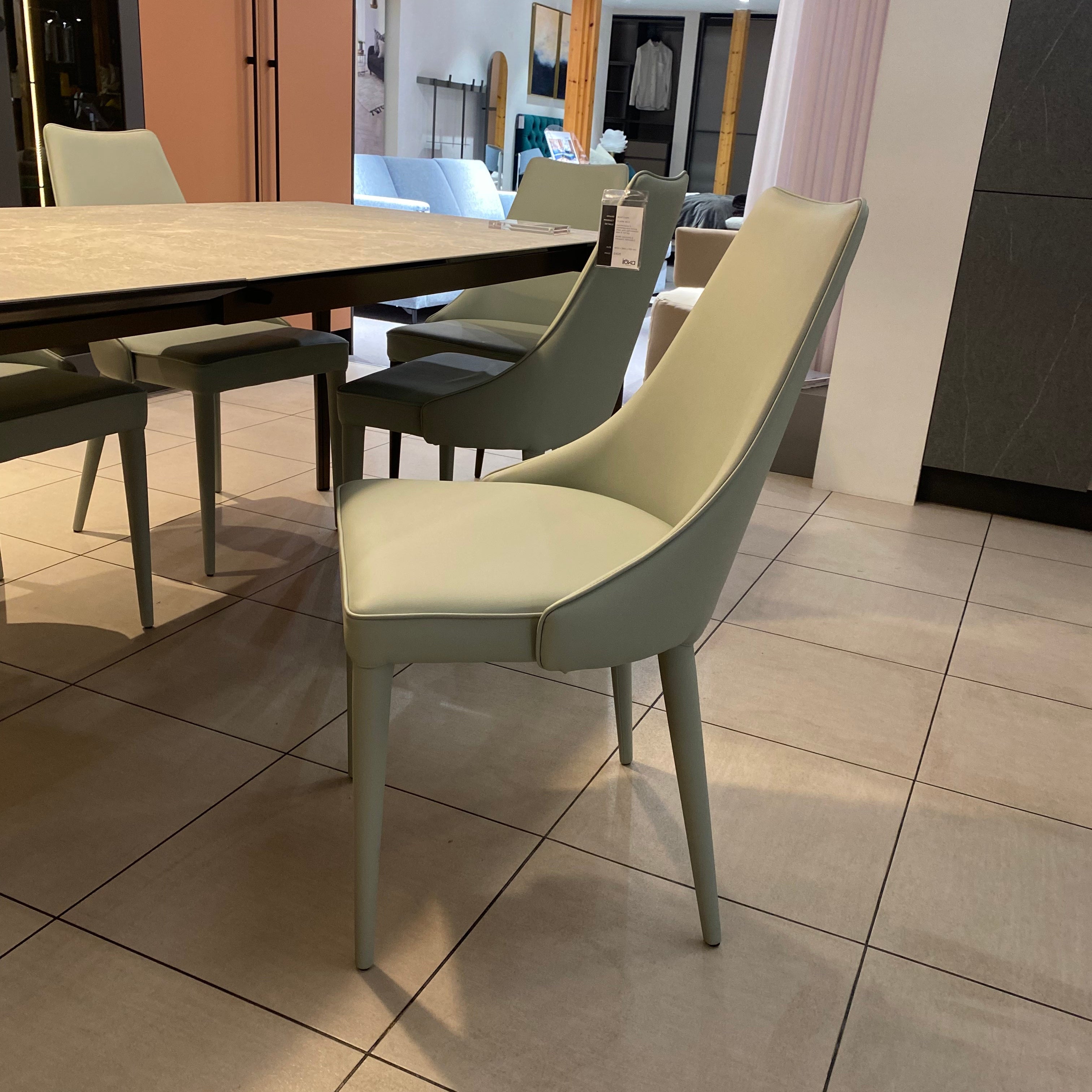 Light green chair on a tiled floor with a blurred background