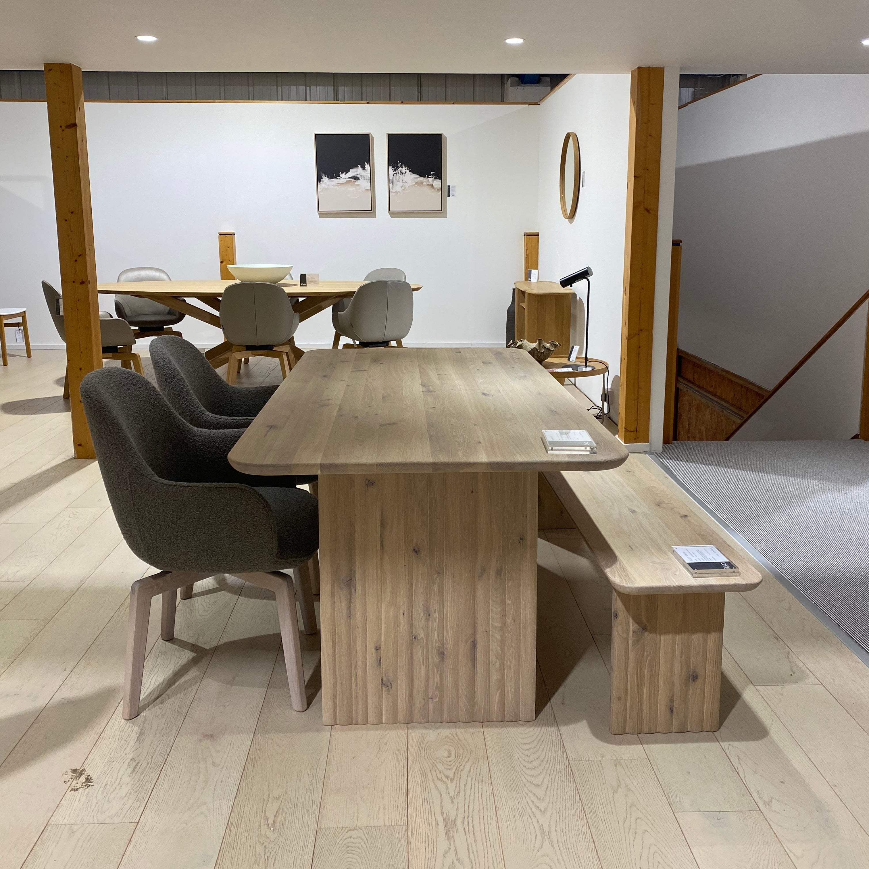Dining area with wooden table and chairs in a modern interior setting.