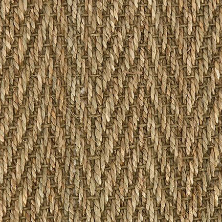Close-up of Fine Herringbone Seagrass carpet in a natural finish, showcasing tightly woven fibres in a subtle zigzag pattern – perfect for adding texture and organic charm to interior spaces.