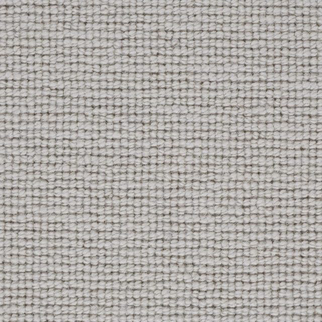 Textured wool carpet swatch in a soft ivory tone, showcasing a uniform loop weave from the Weather Watching Snow Blanket collection.