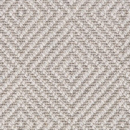 Close-up of a wool carpet swatch in a diamond-patterned loop pile weave, featuring a soft ash grey colour from the Wilton Panache collection.
