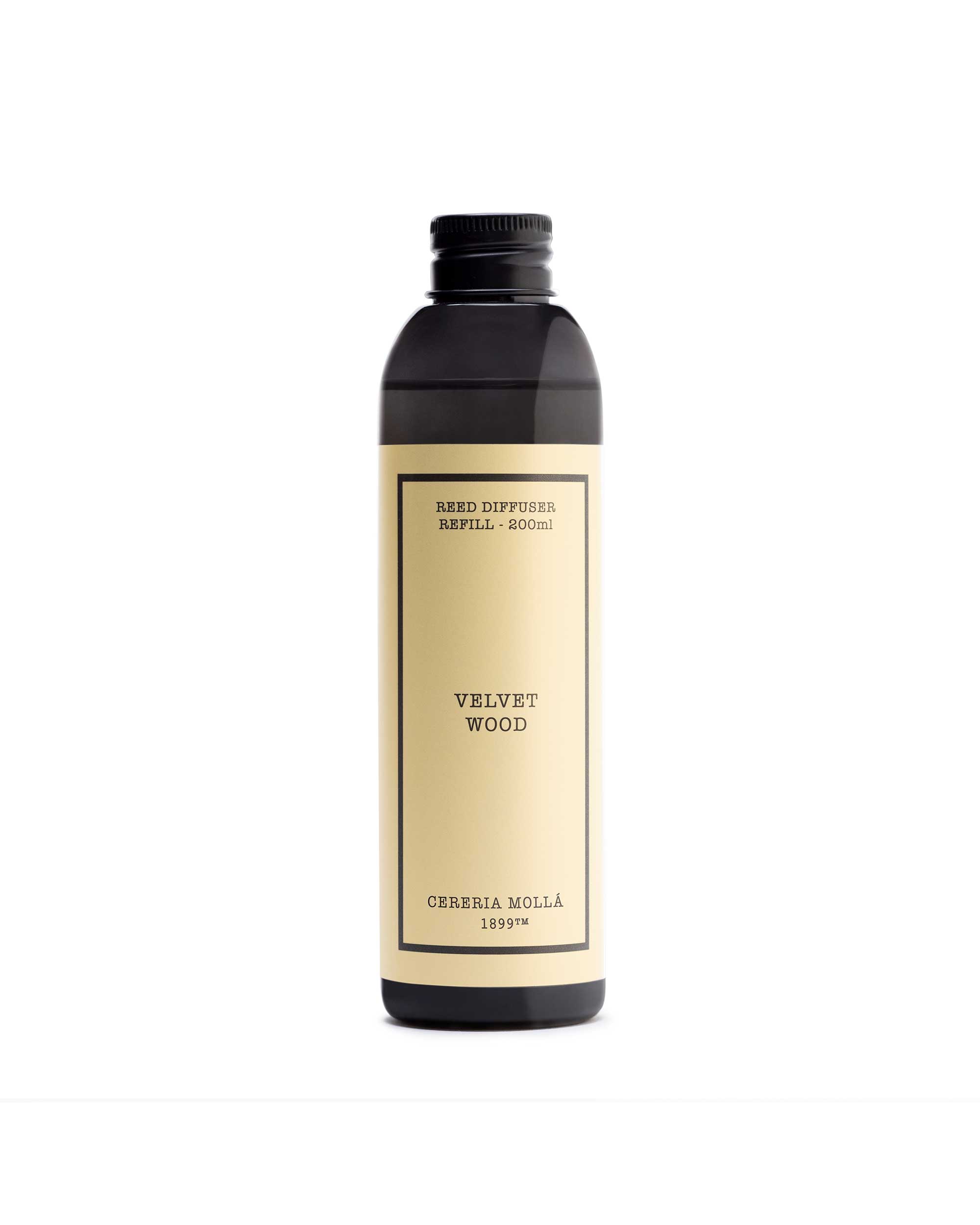 A dark amber glass bottle with a cream-colored label, featuring the brand name 'Cereria Molla' and scent name 'Welvet wood'.