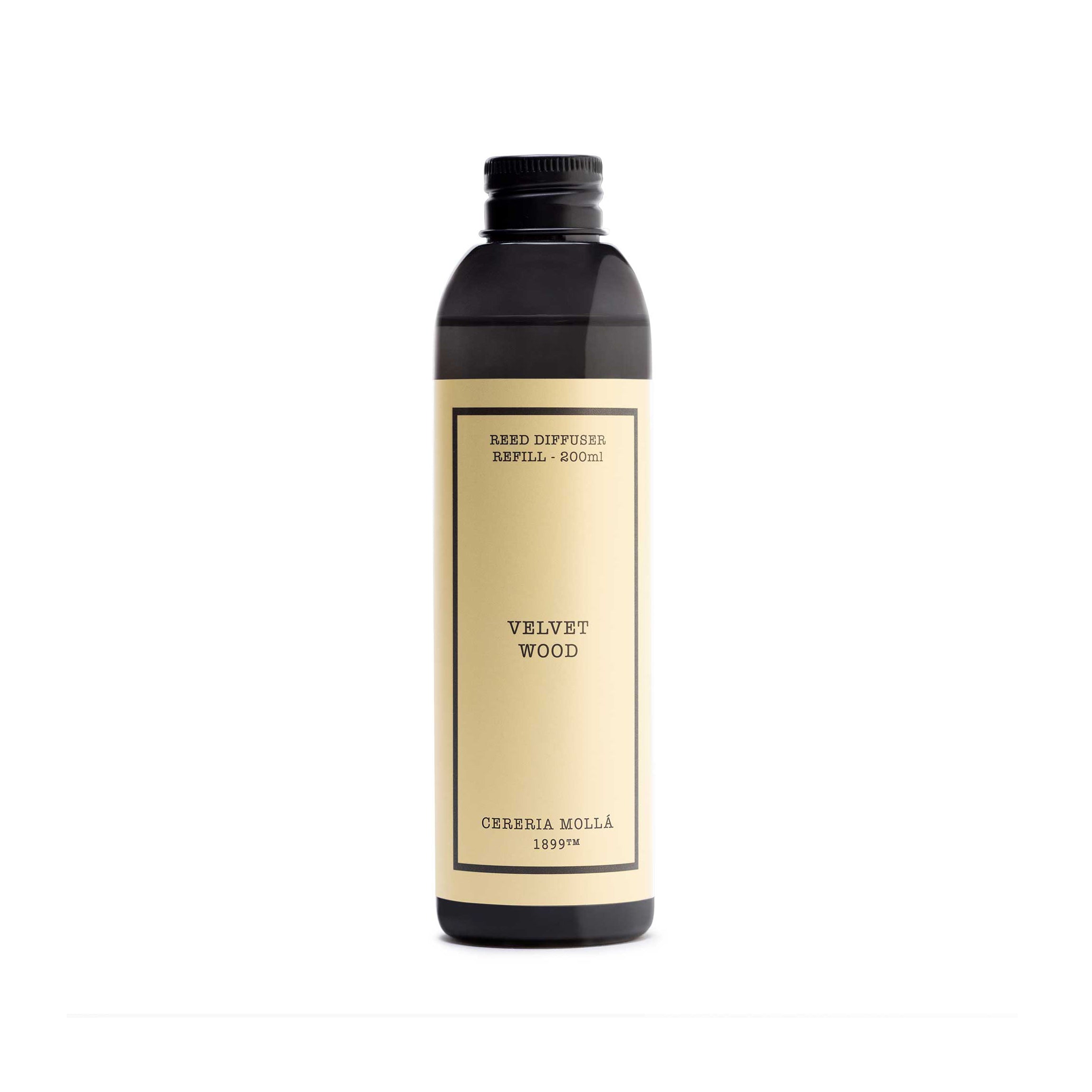 A dark amber glass bottle with a cream-colored label, featuring the brand name 'Cereria Molla' and scent name 'velvet wood'.