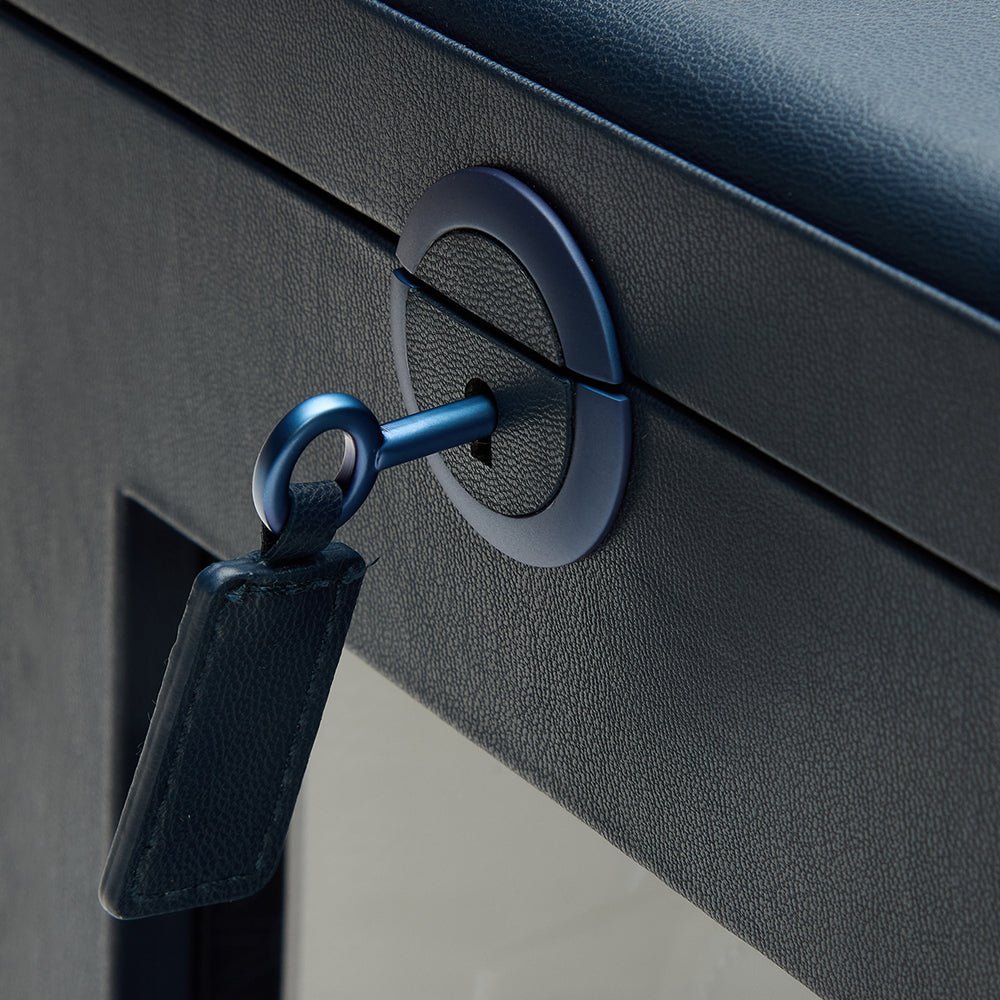 Close-up of a key inserted into blue watch winder box