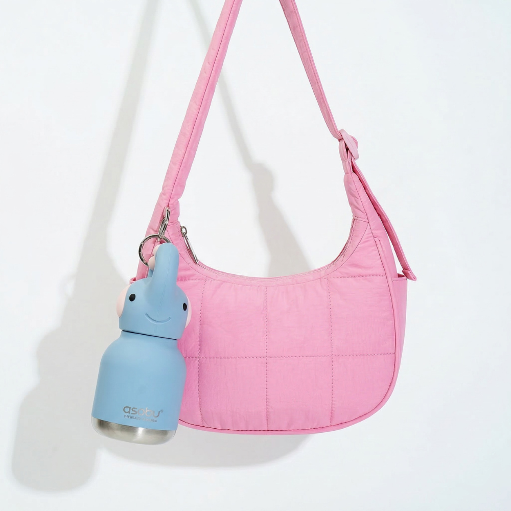Pink handbag with a blue water bottle holder on a white background