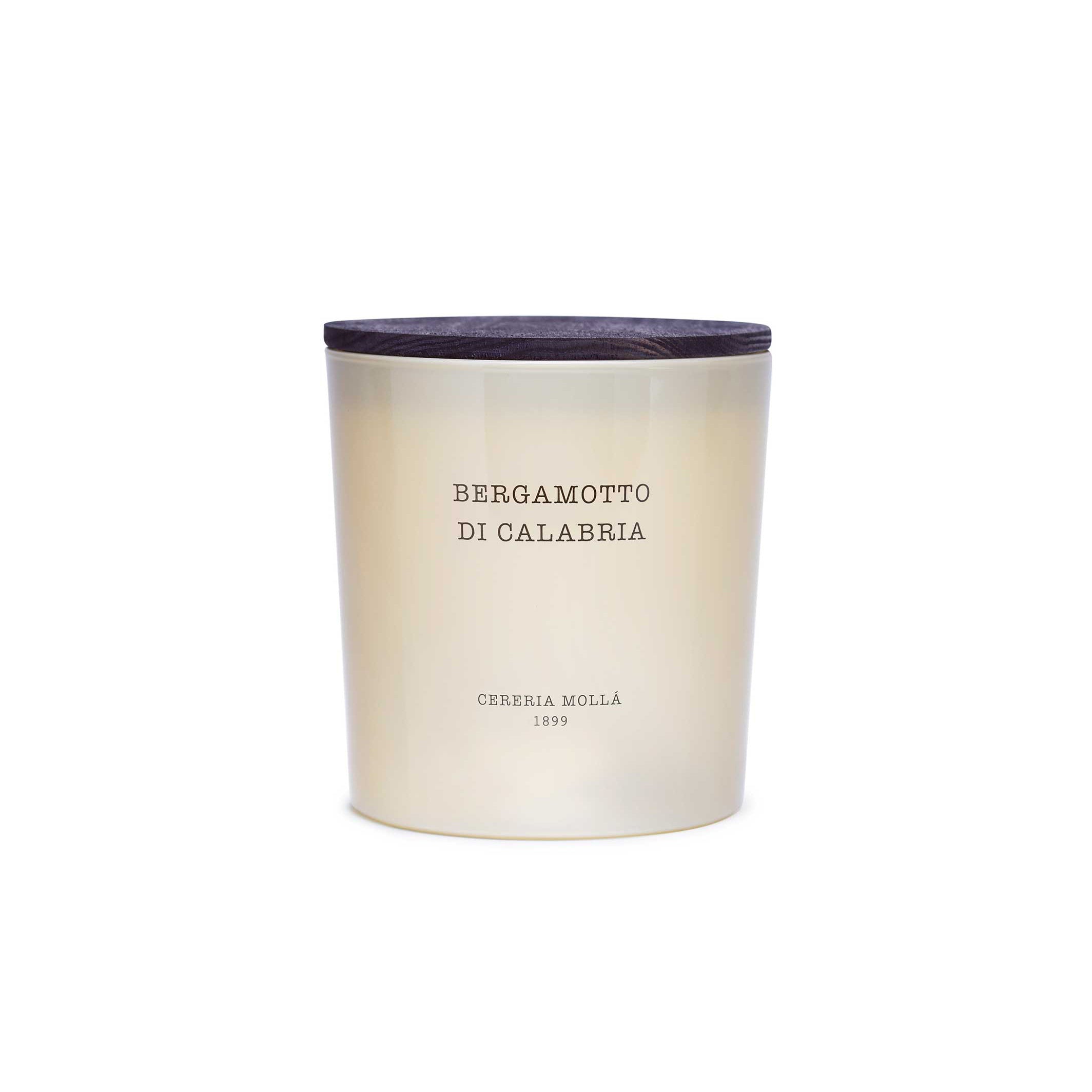 A Cerria Mollà candle in a frosted glass jar with a dark wood lid, labeled 'BERGAMOTTO DI CALABRIA'.