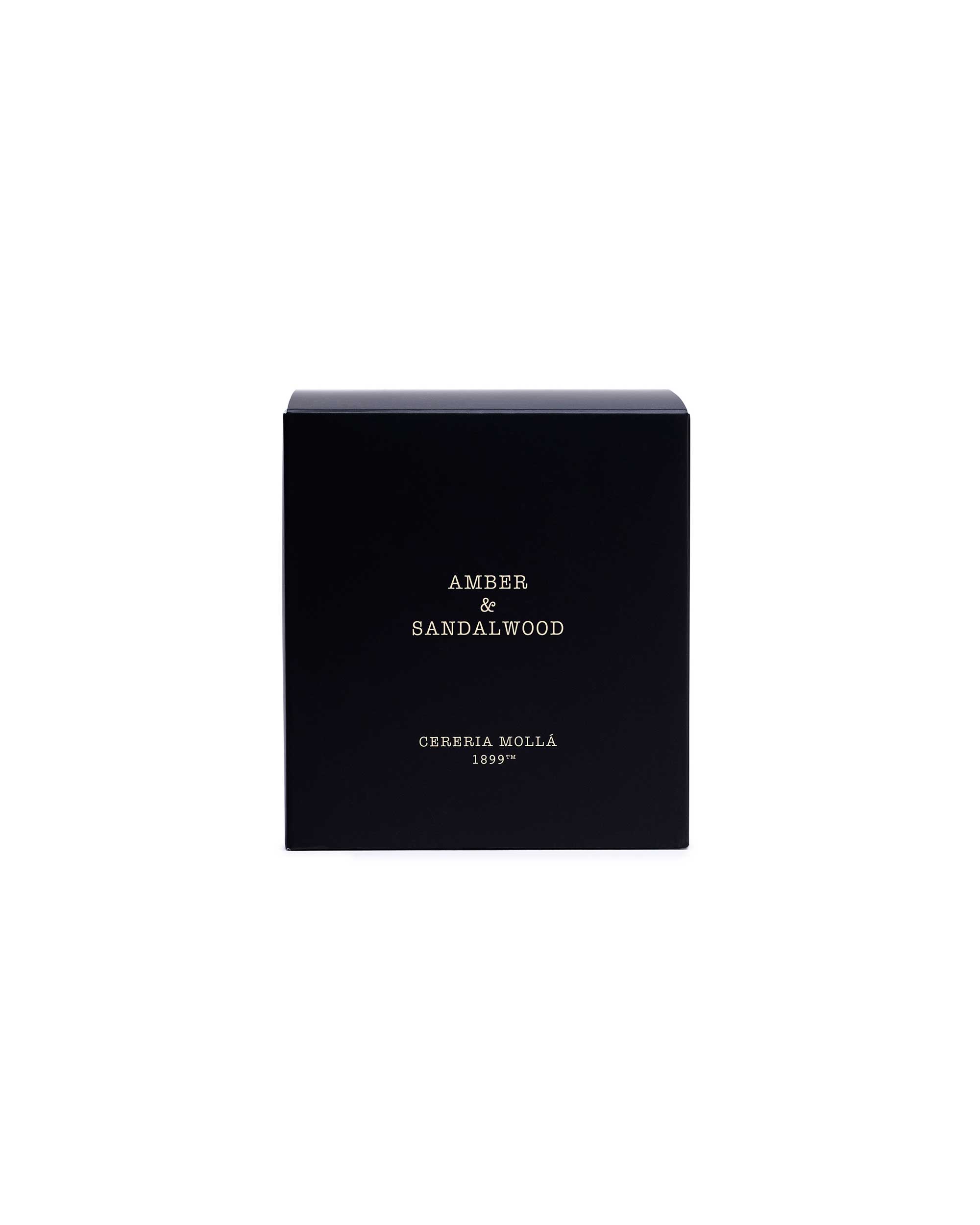 A black rectangular box with gold lettering that reads 'AMBER & SANDALWOOD' and 'CERERIA MOLLA 1899', centered on a plain white background.