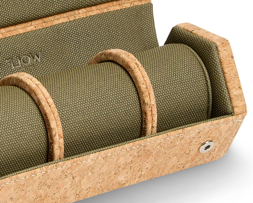 Green fabric roll in a cork-finished wooden holder with 'Wolf 1834' branding.