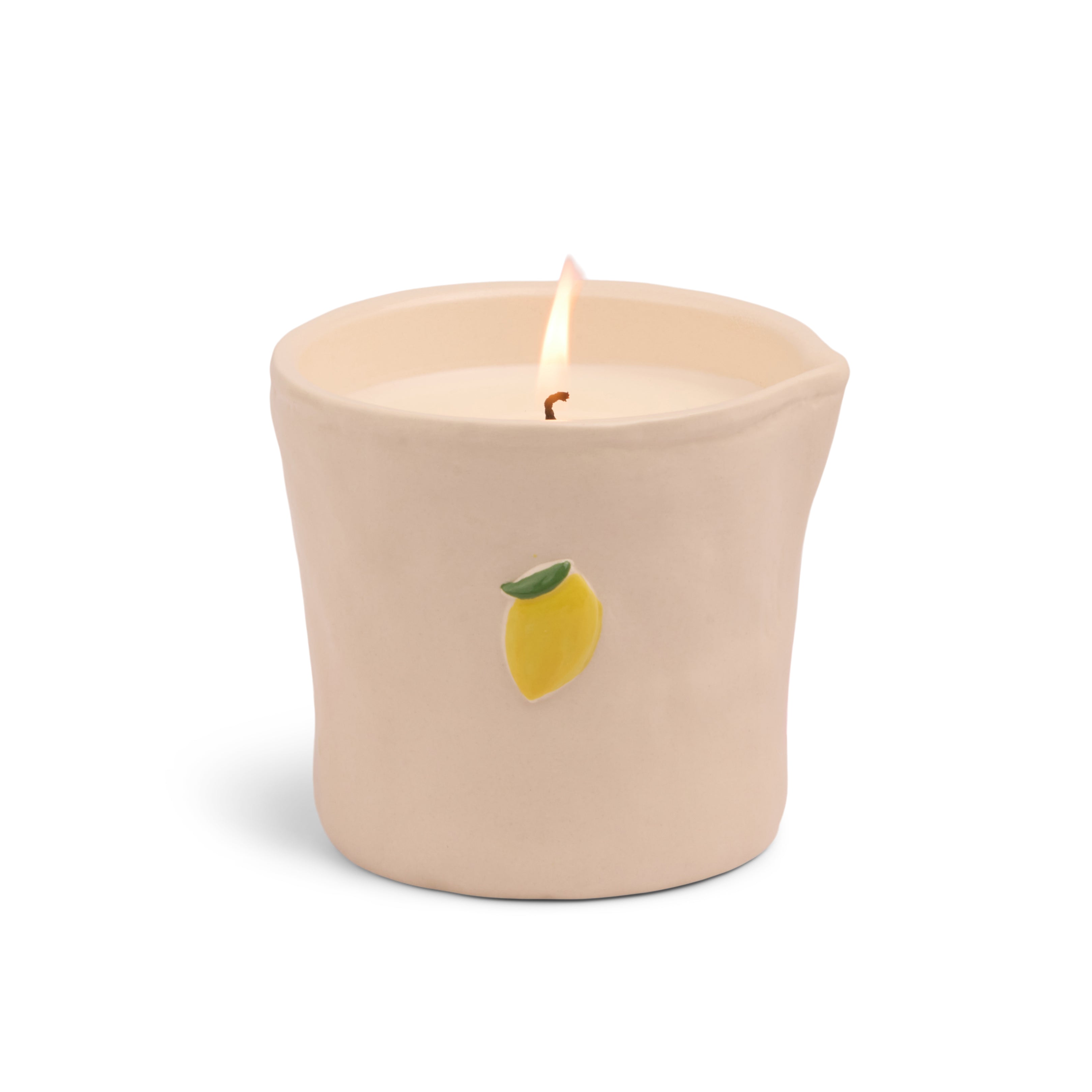 A lit single-wick candle in a beige ceramic pot with a small yellow lemon illustration on the front, set against a plain white background.