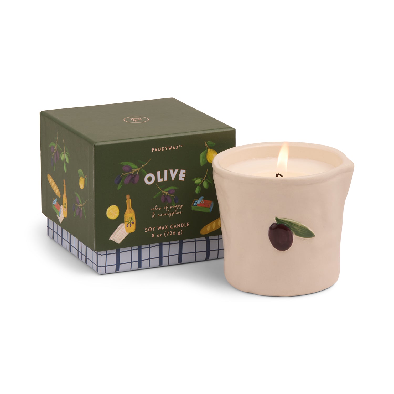 Candle with olive design next to its packaging on a white background