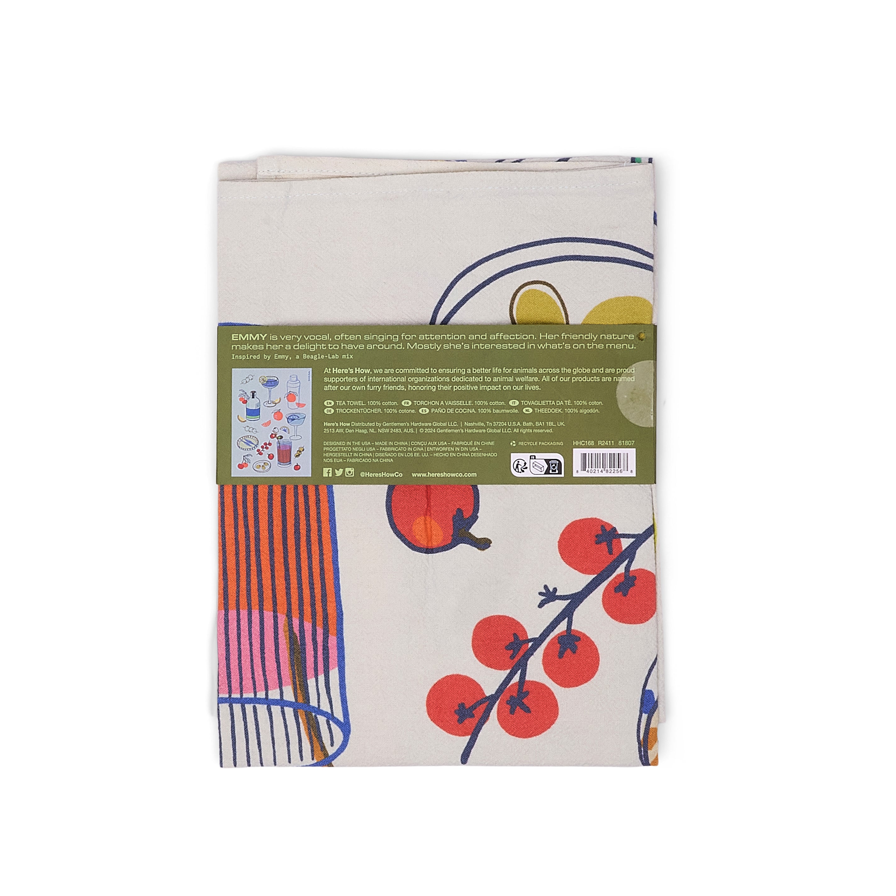 A folder tea towel featuring a cocktail and fruit pattern with a olive green packaging band with product details on.