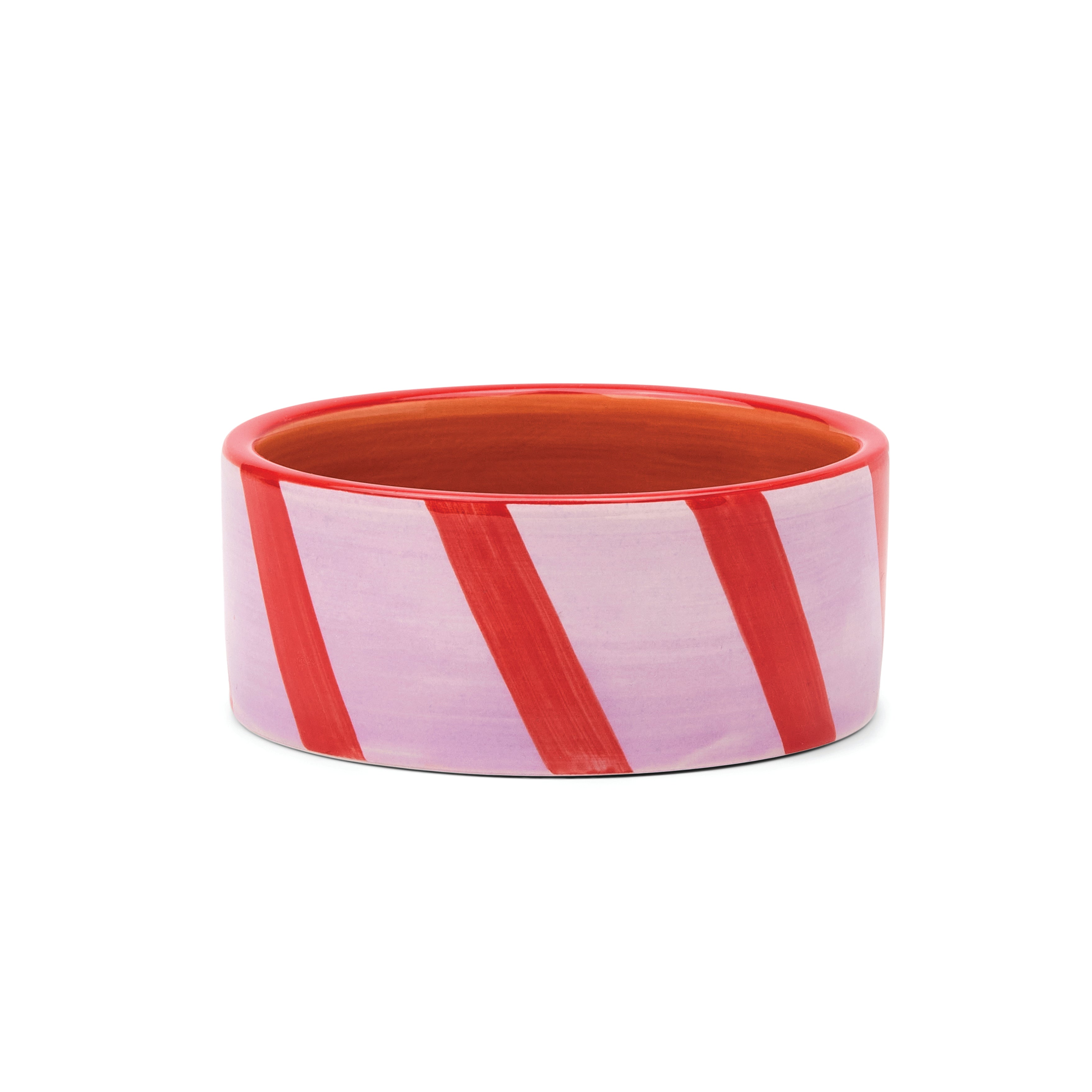 A round ceramic BOTTLE COASTER with a candy cane-inspired pattern of diagonal red stripes on a light lavender-pink background, set against a plain white studio background.