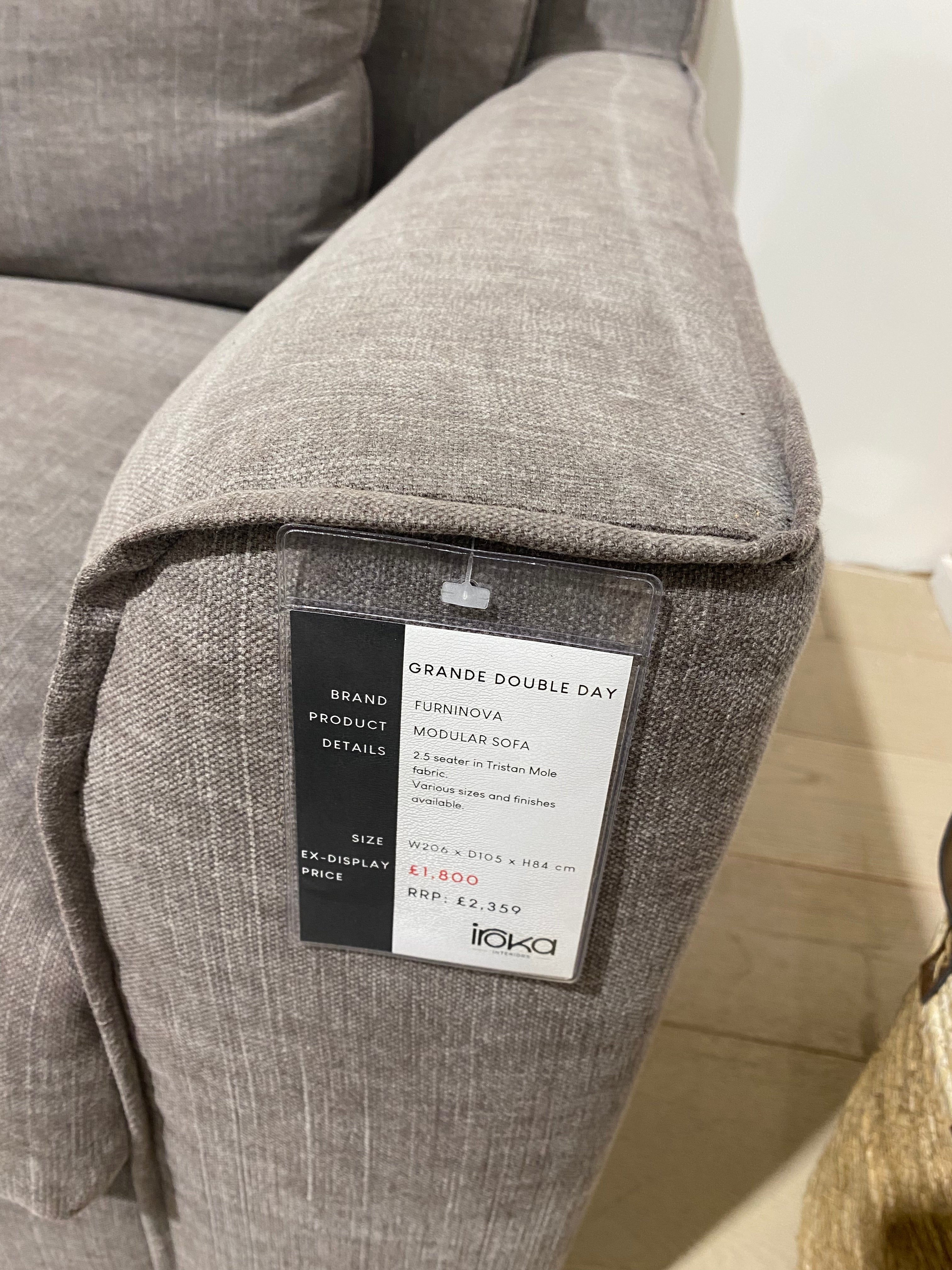 Grey fabric with a label on a beige surface
