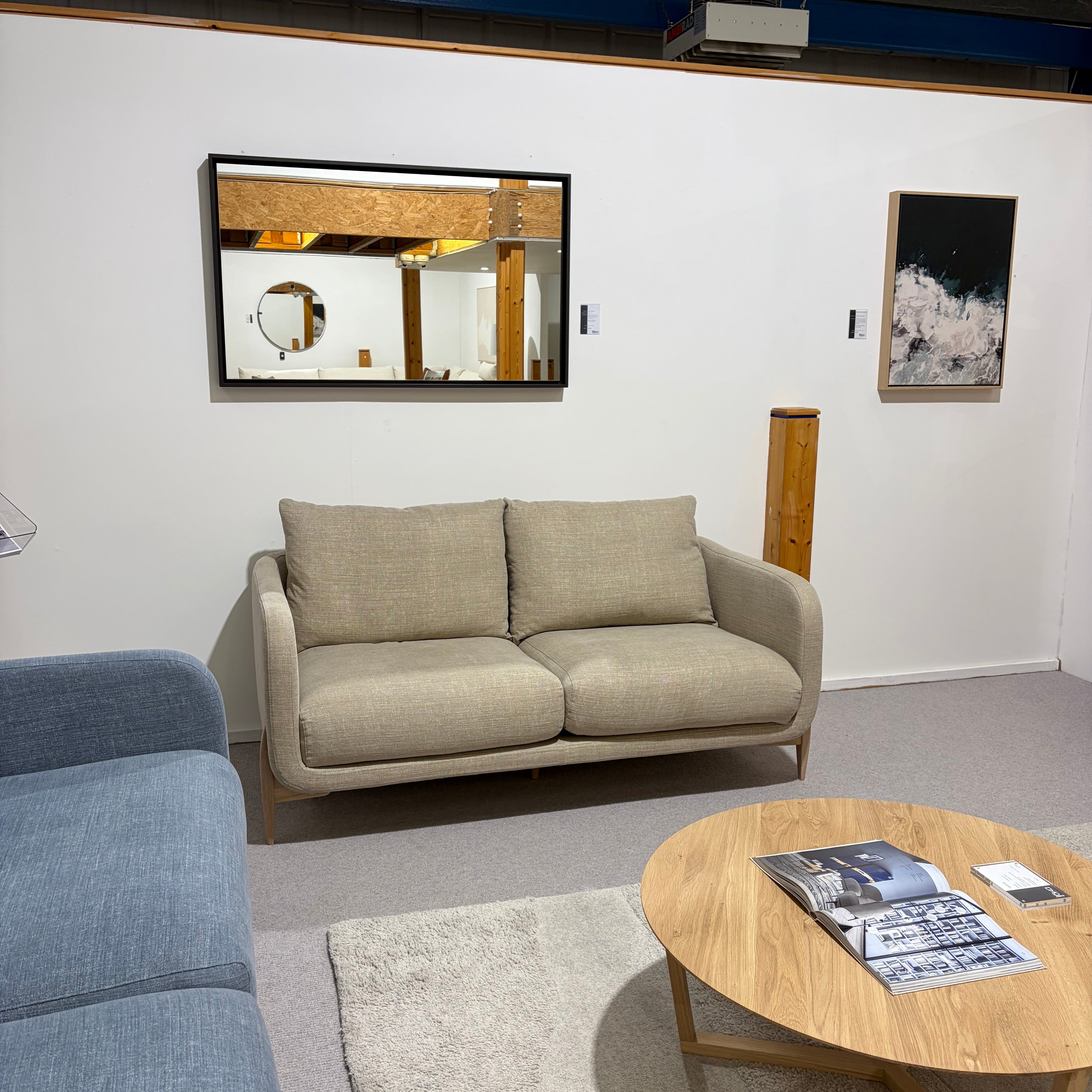 Living room with beige sofa, wooden coffee table, and gray rug.