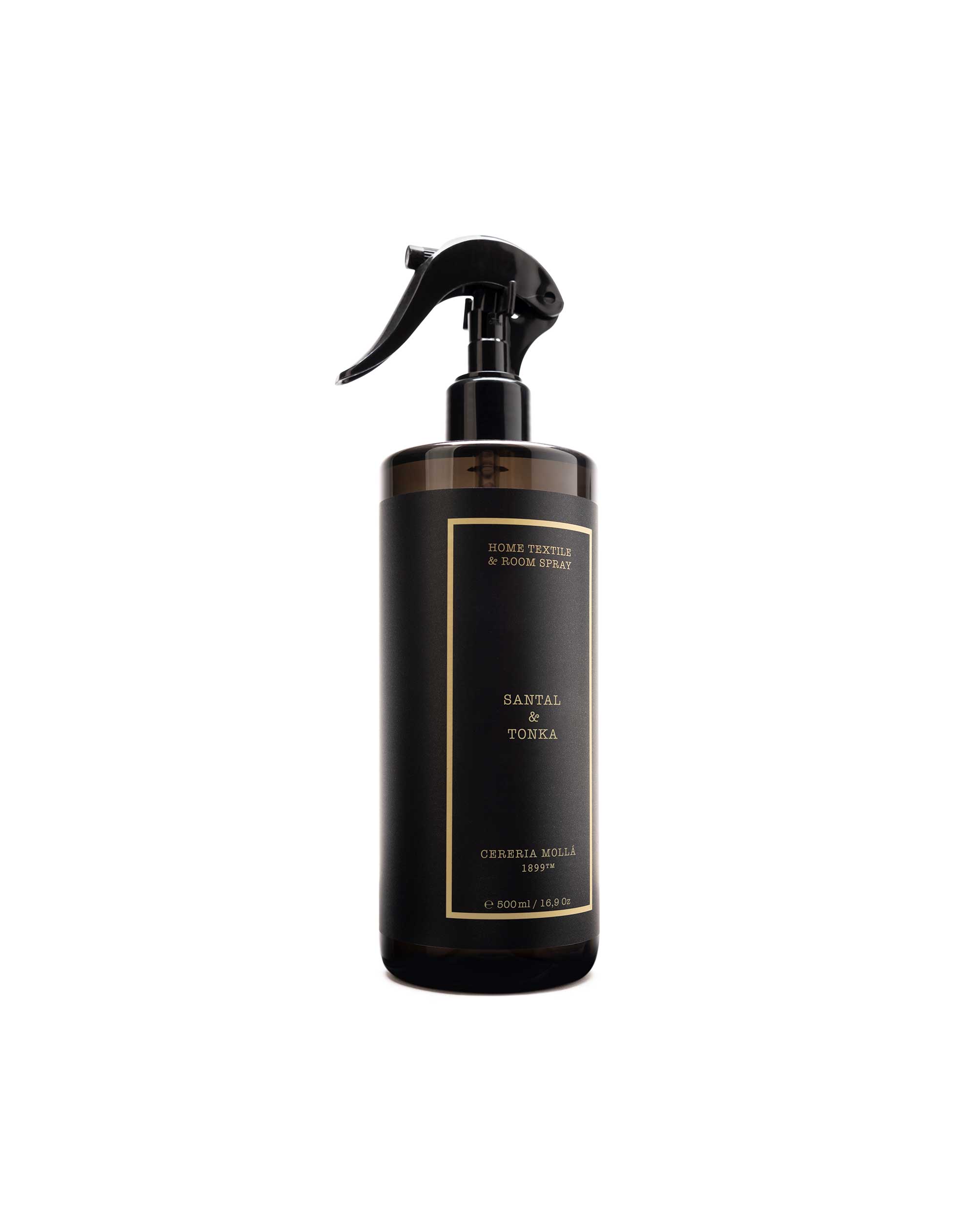 A dark brown glass spray bottle with a black trigger sprayer and a black label featuring gold text, labeled 'santal & tonka and 'Cereria molla.